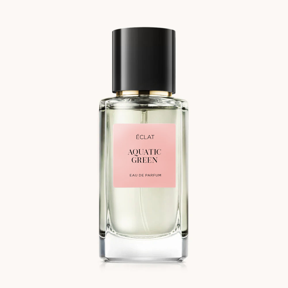 Flacon of the women’s perfume dupe ÉCLAT Aquatic Green RAR, an elegant transparent glass bottle with a black cylindrical magnetic cap and a dark pink label. The label displays the brand name ÉCLAT, the name Aquatic Green RAR, and the phrase “Eau de Parfum”.