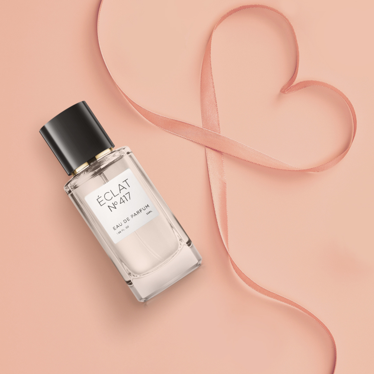 ÉCLAT perfume bottle with pink ribbon shaped like a heart – a thoughtful Mother’s Day gift idea