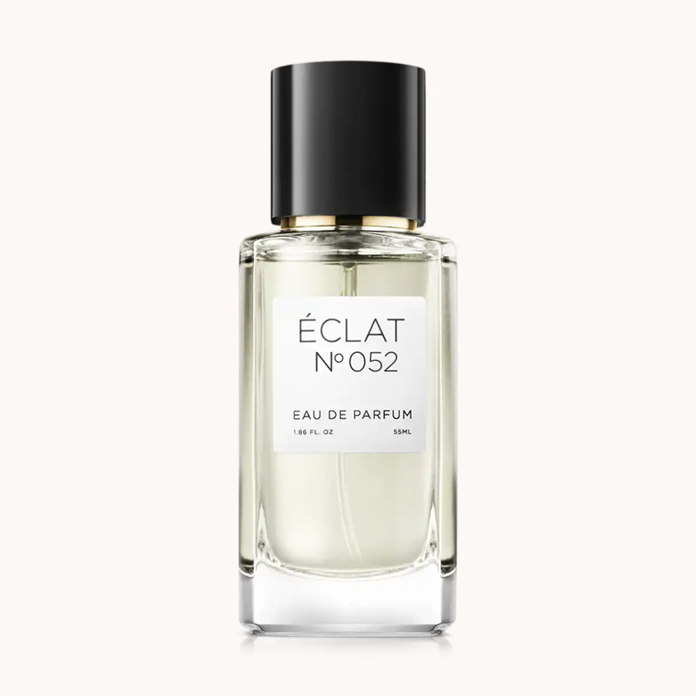 Flacon of the women's fragrance dupe ÉCLAT No. 052 RAR, an elegant transparent glass bottle with a black cylindrical magnetic cap and a white label. The label features the brand name ÉCLAT, the number 052 RAR, and the words “Eau de Parfum”.