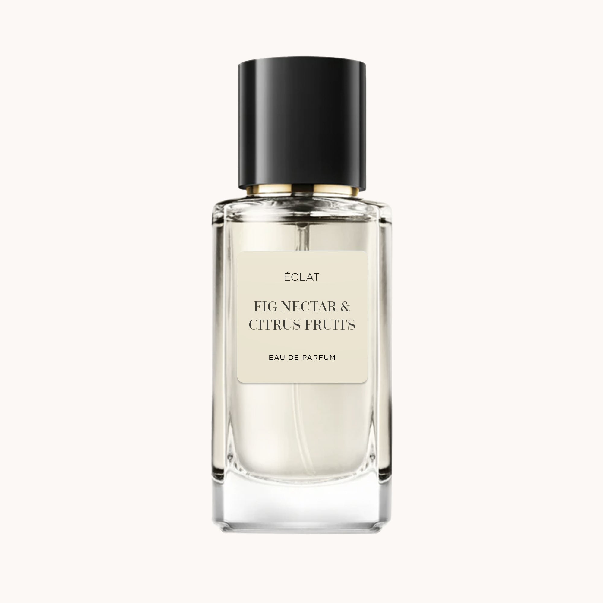 Elegancka szklana butelka ÉCLAT Fig Nectar & Citrus Fruits z czarną nakrętką i miękką beżową etykietą.