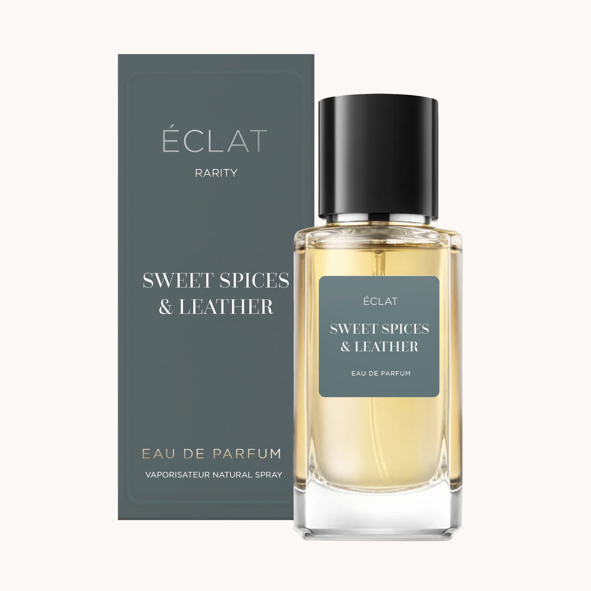 Flakon ÉCLAT Sweet Spices & Leather z przezroczystego szkła i czarną nakrętką, obok pasującego pudełka.
