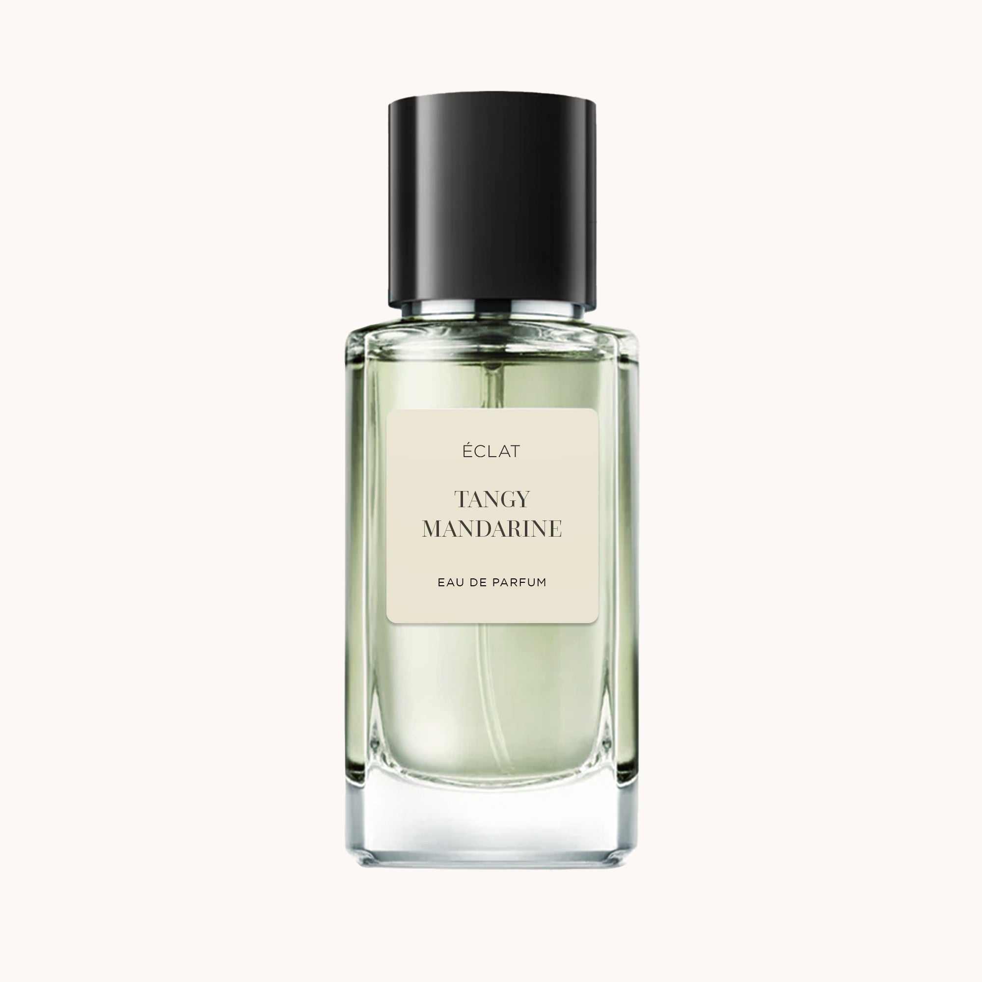 Przezroczysta szklana butelka perfum ÉCLAT Tangy Mandarine z czarną nakrętką i kremową etykietą.