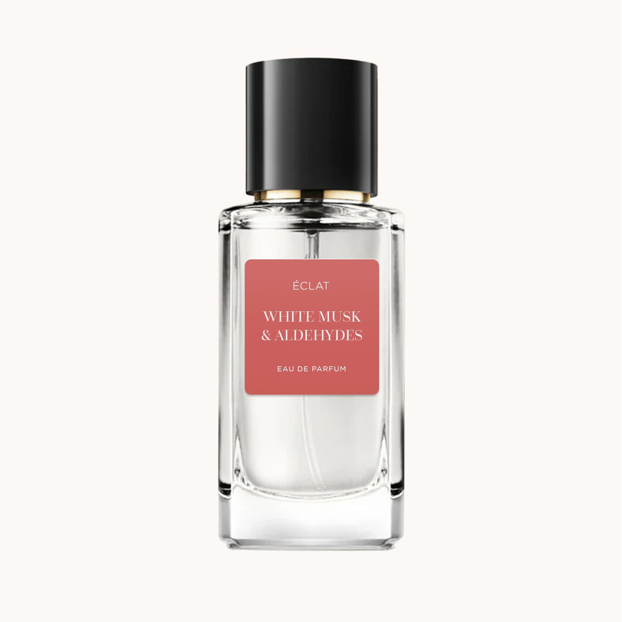 ÉCLAT White Musk & Aldehydes w fasetowanej szklanej butelce z czarną nakrętką i matową różową etykietą.