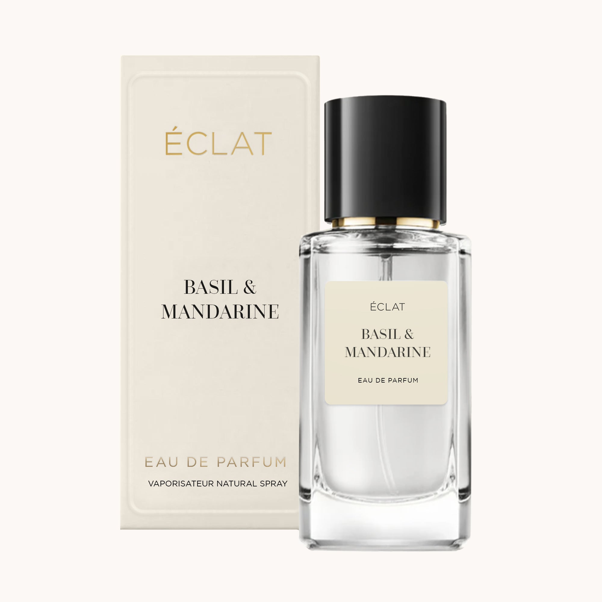 Fasetowany szklany flakon perfum ÉCLAT Basil & Mandarine z czarną nakrętką, w towarzystwie wyrafinowanego kremowego pudełka.