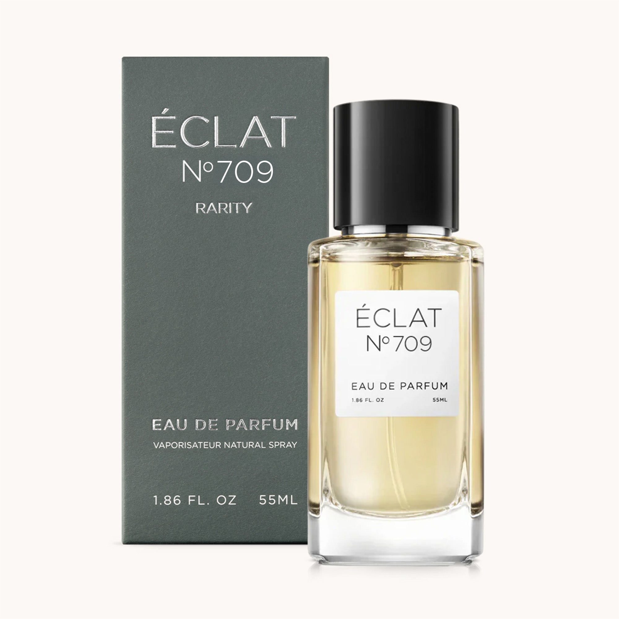 ÉCLAT Black Tea & Cedar w fasetowanej szklanej butelce z czarną nakrętką, obok eleganckiego ciemnego pudełka.