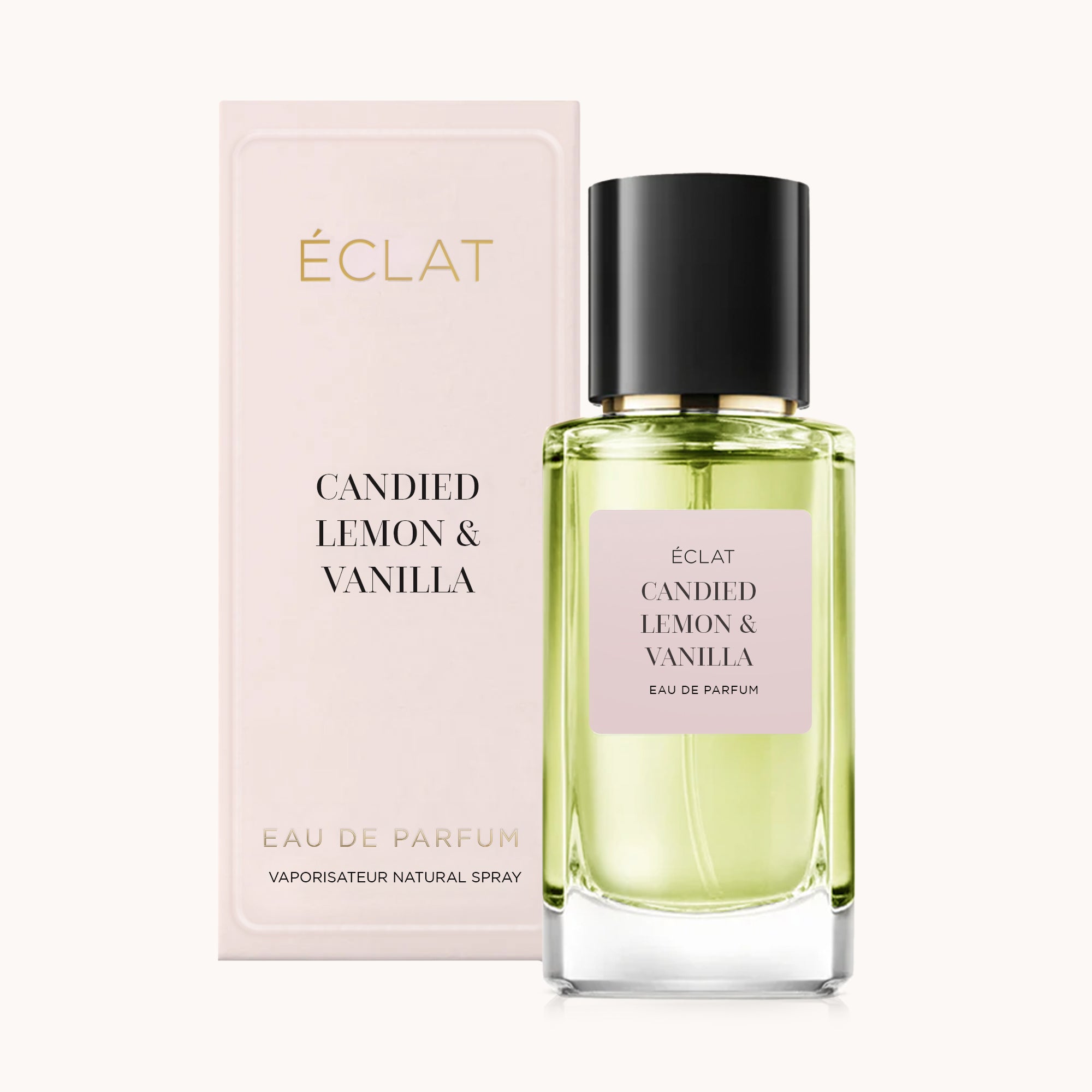 Flakon perfum ÉCLAT Candied Lemon & Vanilla z pastelowo-różowym pudełkiem i czarną nakrętką.
