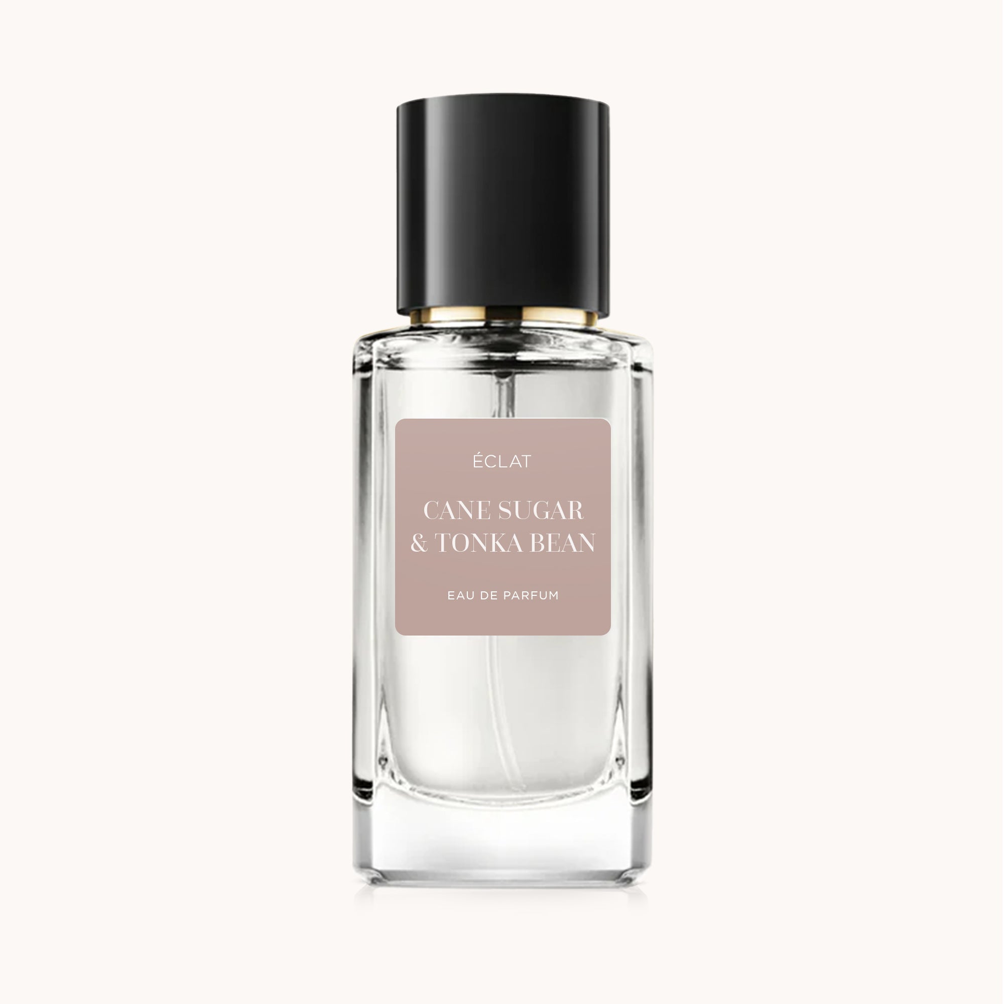 Fasetowana szklana butelka z matową czarną nakrętką, z etykietą ÉCLAT Cane Sugar & Tonka Bean.