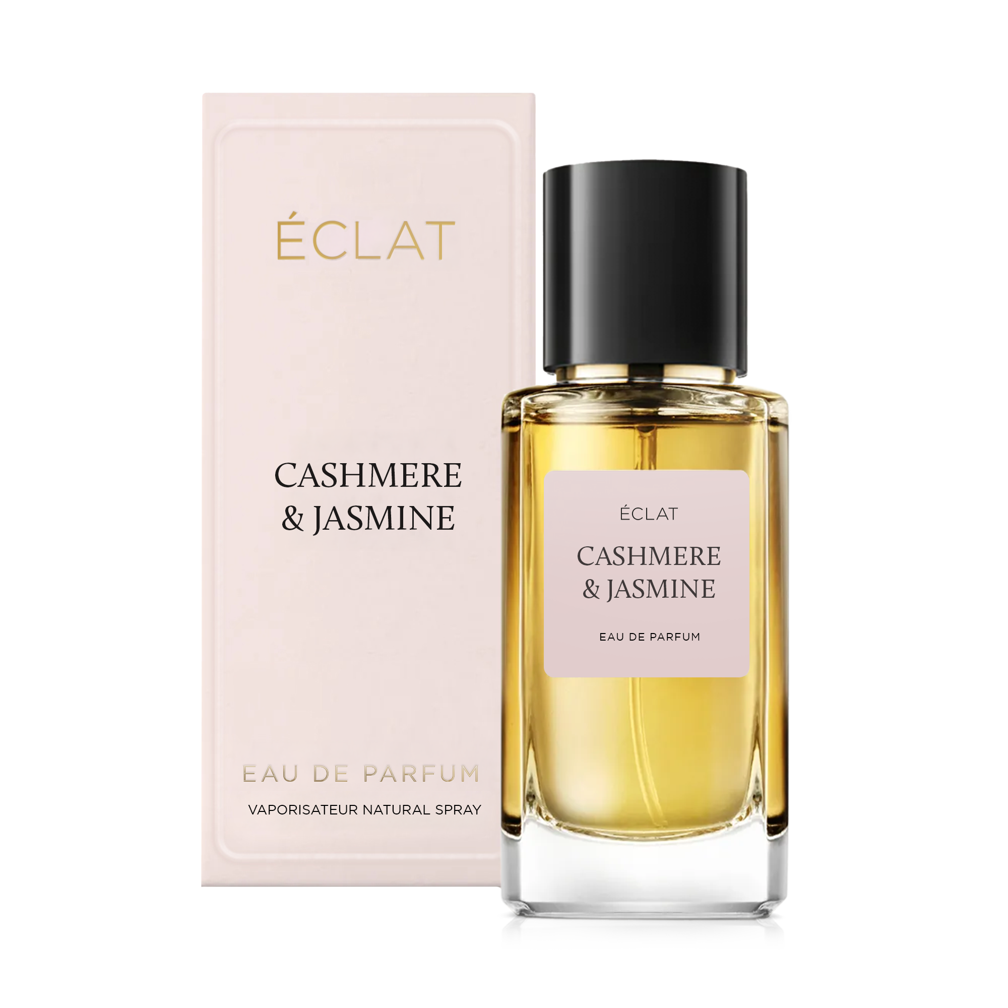 Facetowany szklany flakon z delikatną różową etykietą i czarną nakrętką, obok eleganckiego pudełka z ÉCLAT Cashmere & Jasmine.