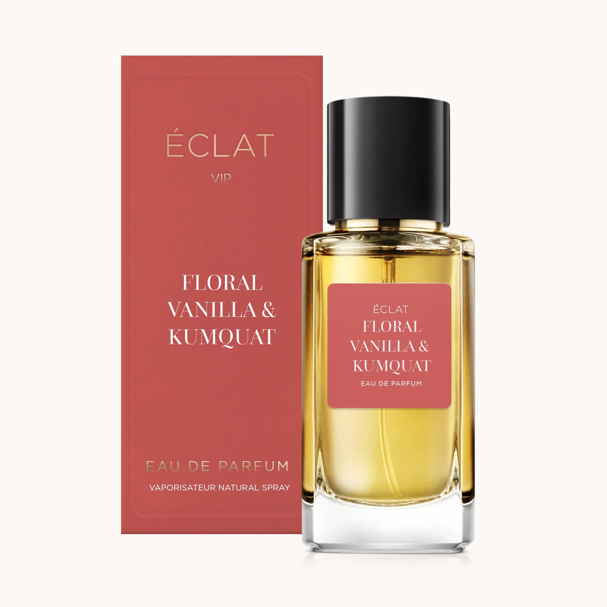 Flakon perfum ÉCLAT Floral Vanilla & Kumquat z różową etykietą i dopasowanym pudełkiem, z czarną nakrętką.