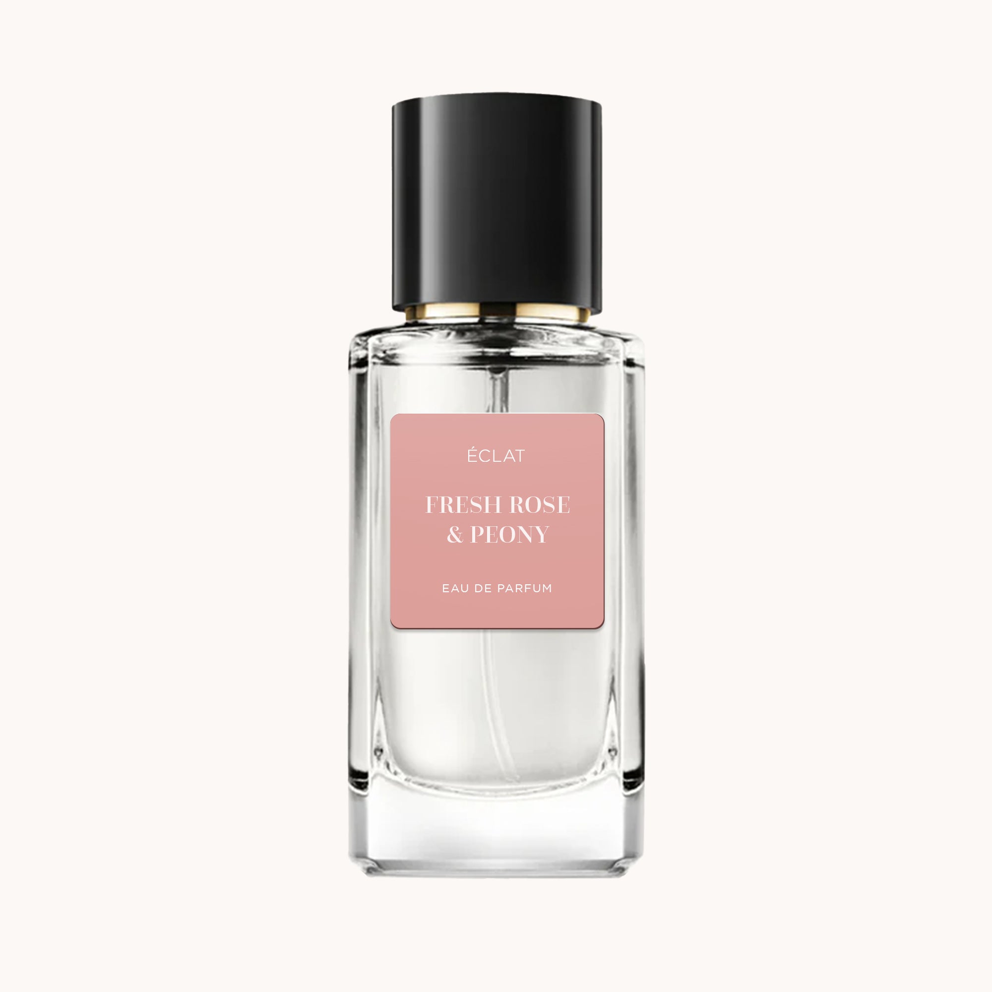 Fasetonowa szklana butelka ÉCLAT Fresh Rose & Peony z matową różową etykietą i czarną nakrętką.