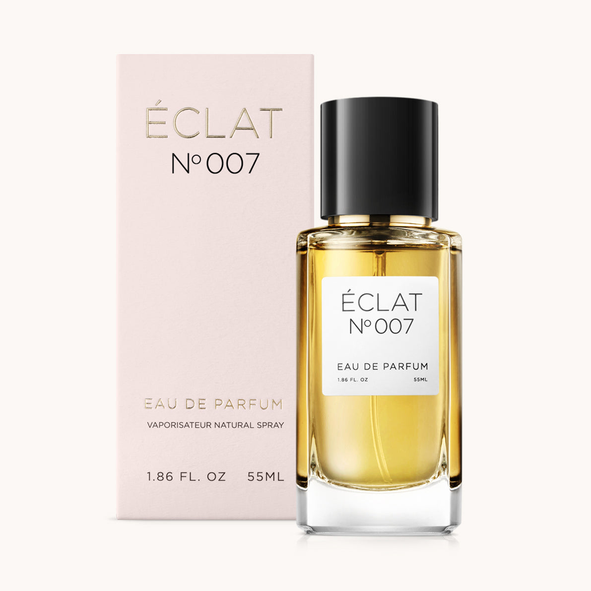 Perfumy ÉCLAT Oriental Cloves z przezroczystą szklaną butelką i czarną nakrętką, obok różowego pudełka ze złotymi literami.