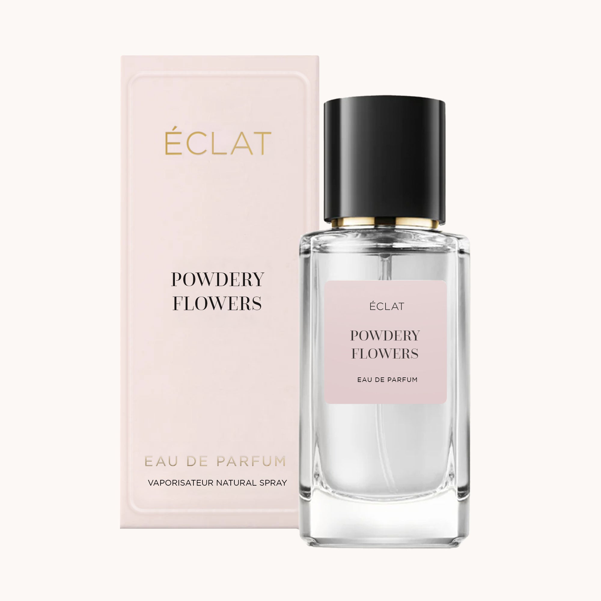 Fasetowany szklany flakon ÉCLAT Powdery Flowers z czarną nakrętką, obok bladoróżowego opakowania.
