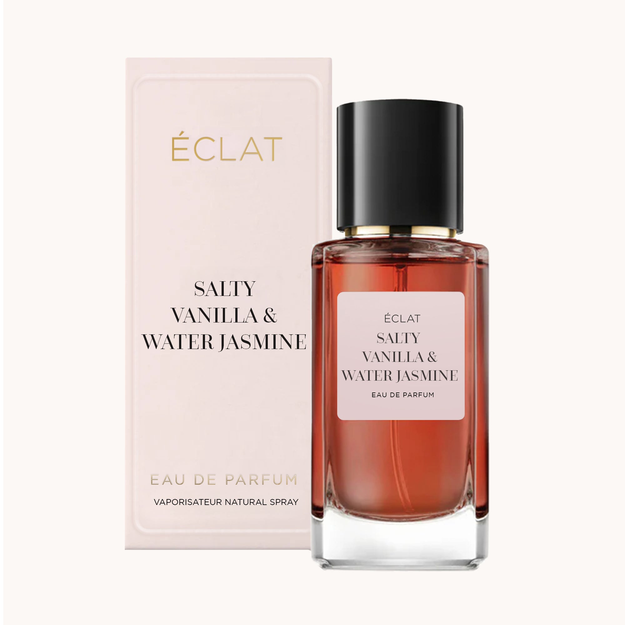 Perfumy ÉCLAT Salty Vanilla & Water Jasmine z bursztynową szklaną butelką i czarną nakrętką, w towarzystwie jasnego pudełka.