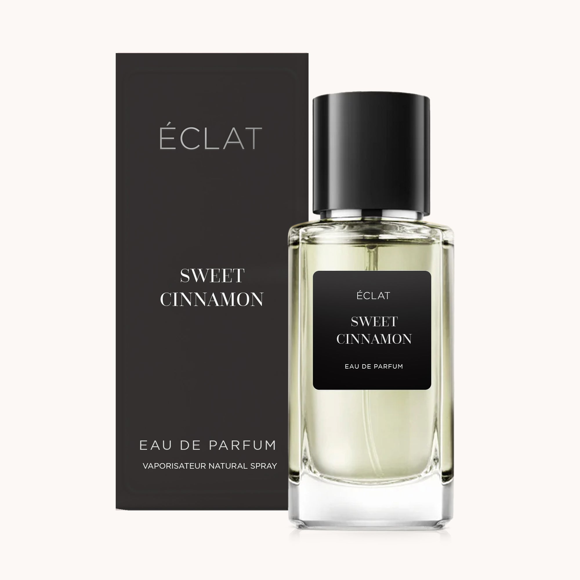 Szklany flakon ÉCLAT Sweet Cinnamon z czarną etykietą i pasującym czarnym pudełkiem w tle.
