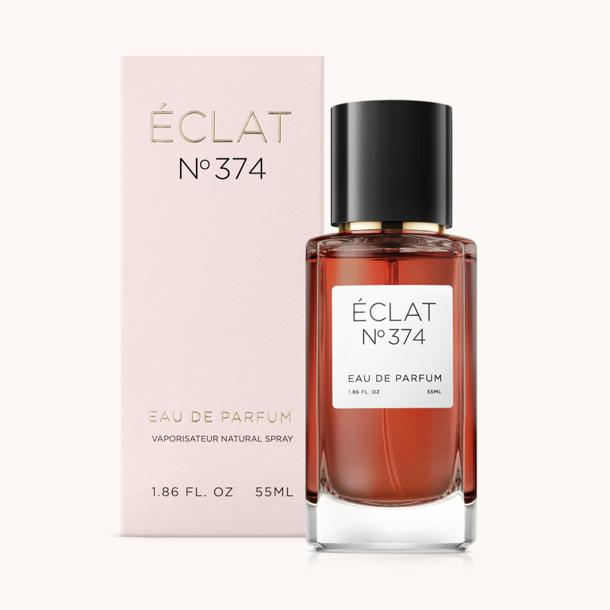 Perfumy ÉCLAT Sweet Honey w przezroczystej szklanej butelce z czarną zakrętką, obok jasnoróżowego pudełka ze złotymi literami.