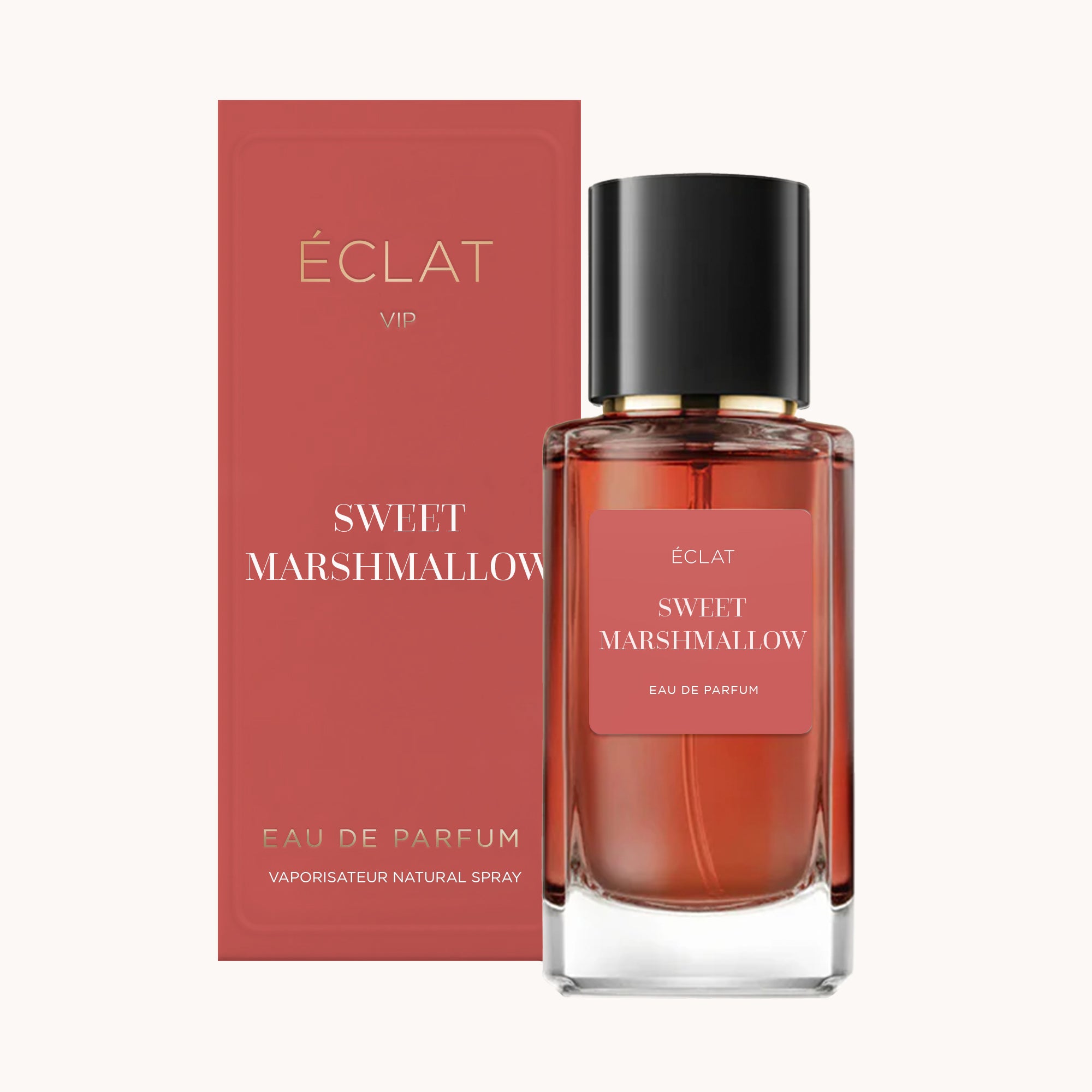 Flakon perfum ÉCLAT Sweet Marshmallow z przezroczystego szkła z czarną nakrętką, obok pasującego różowego pudełka.