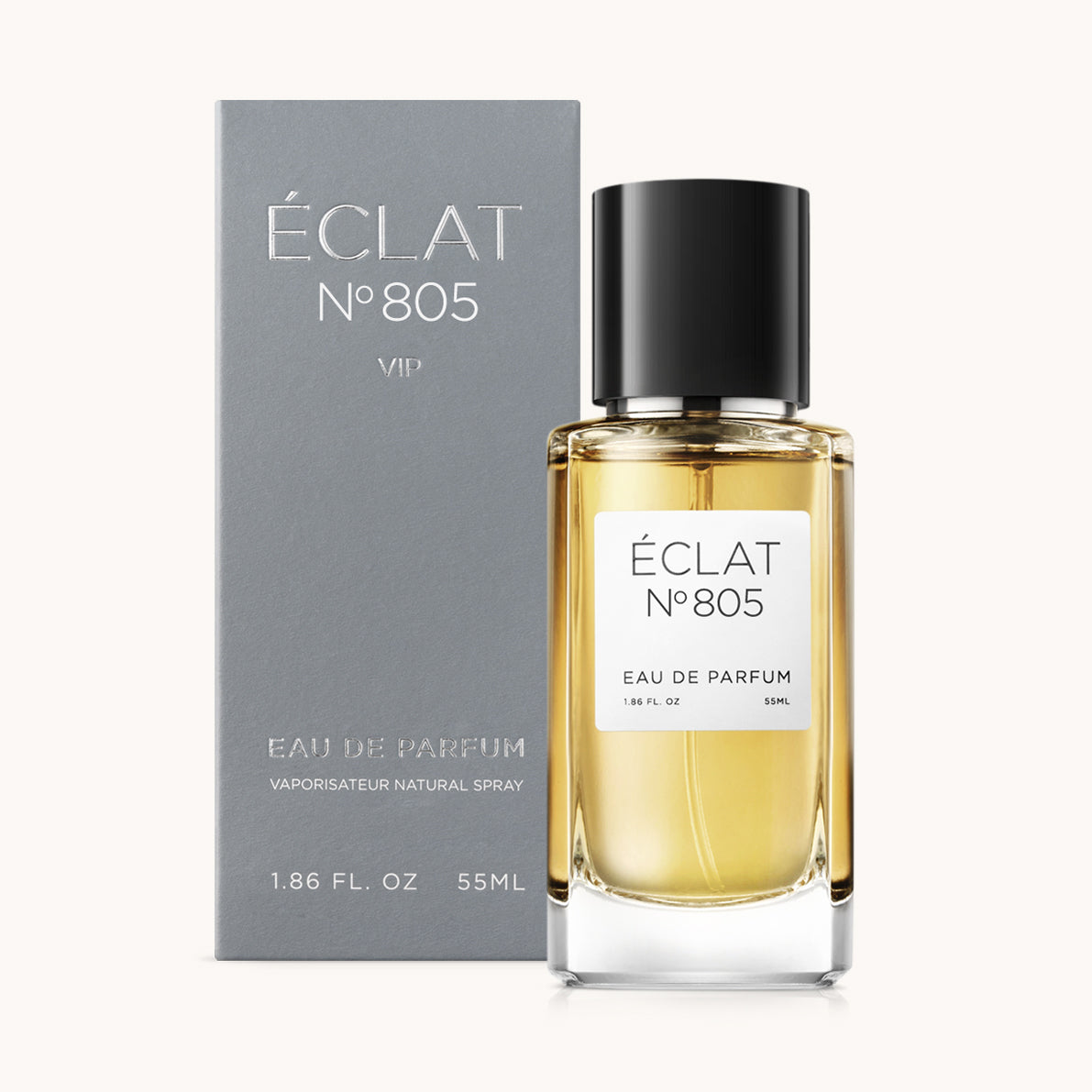 Perfumy ÉCLAT Sweet Nutmeg w szklanej butelce z czarnym korkiem, w towarzystwie eleganckiego szarego pudełka.