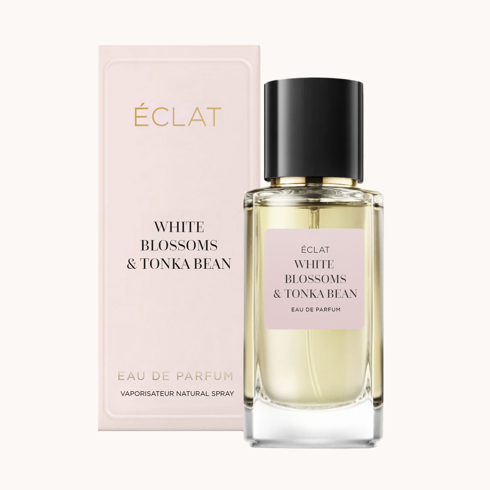ÉCLAT White Blossoms & Tonka Bean w fasetowanej szklanej butelce z czarną nakrętką, ustawione obok eleganckiego pudełka ze złotymi literami.
